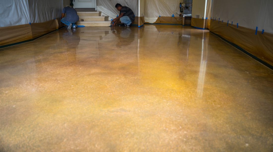 Installers finishing a coated floor